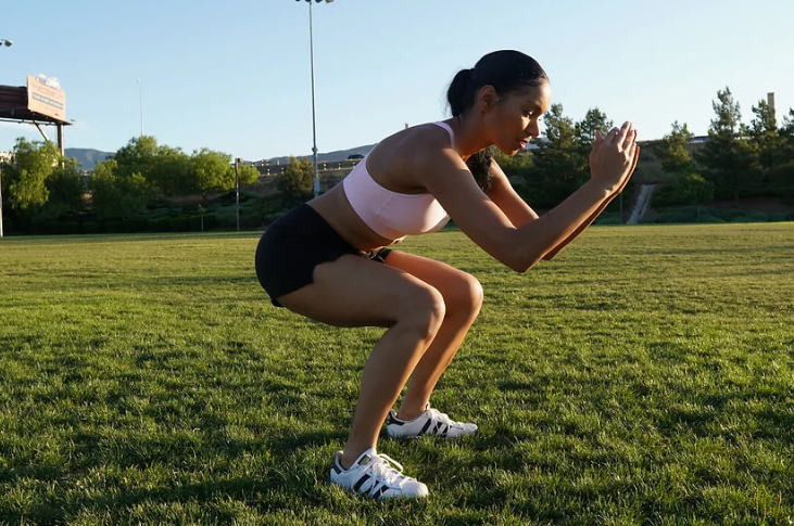 girl doing squats in the park