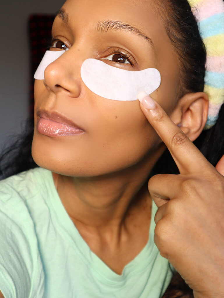 woman with under-eye patches on to make eyes pop