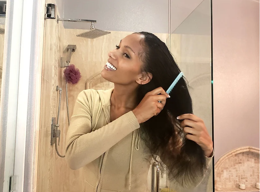 woman combing hair as an easy way to look better instantly