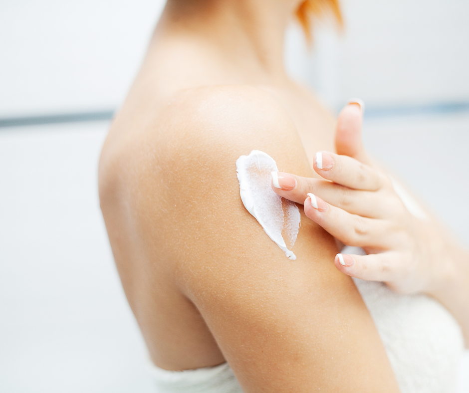woman applying body lotion